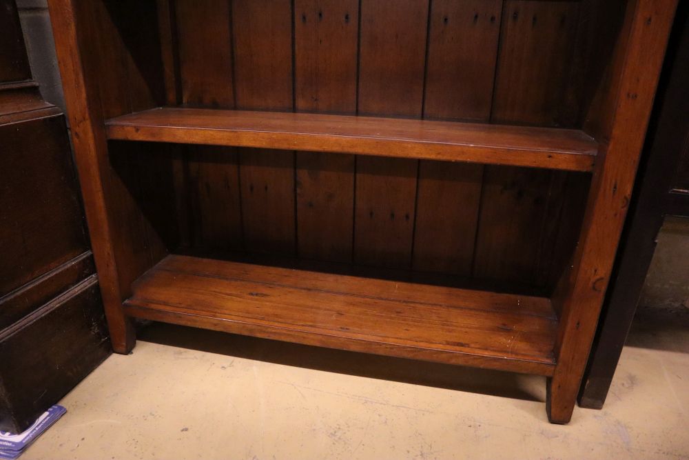 A modern stained pine open shelved bookcase, width 98cm depth 33cm height 198cm